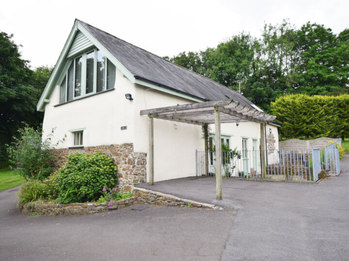 Views towards the cottage with enclosed patio area.