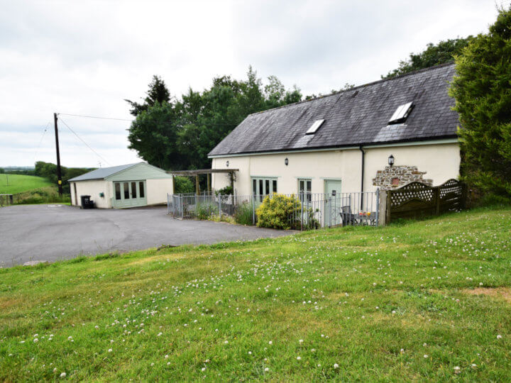 Views towards the cottage with enclosed patio area.